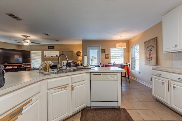 kitchen featuring sink, pendant lighting, dishwasher, white cabinetry, and light tile patterned flooring