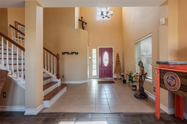 foyer entrance with a towering ceiling and an inviting chandelier