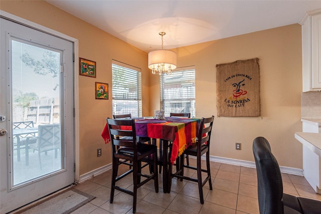 tiled dining space with a chandelier and plenty of natural light