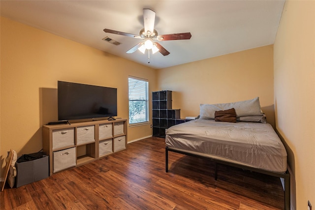 bedroom featuring ceiling fan and dark wood-type flooring