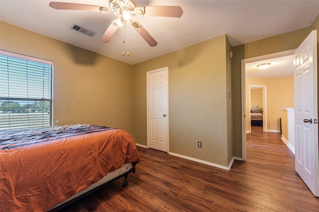 bedroom featuring ceiling fan and dark hardwood / wood-style flooring