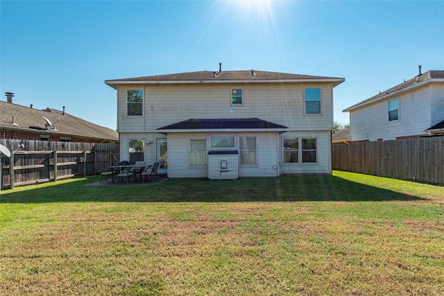 back of property featuring a yard and a patio