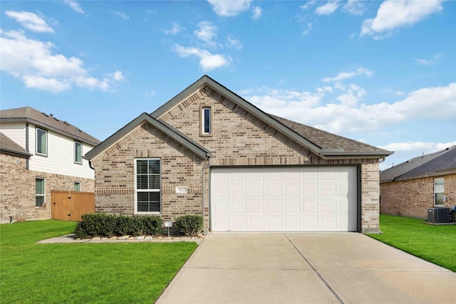 9211 Melmack Dr, Rosharon, TX 77583 - view of front of home featuring brick siding, central AC unit, concrete driveway, a front lawn, and an attached garage