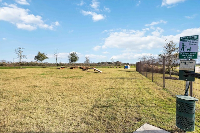 view of yard featuring a rural view and fence