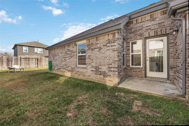 back of house with a patio area and a yard