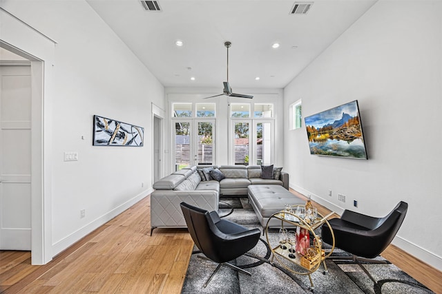 living room featuring ceiling fan and light hardwood / wood-style flooring