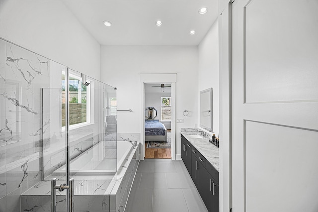 bathroom featuring tile patterned flooring, shower with separate bathtub, vanity, and ceiling fan