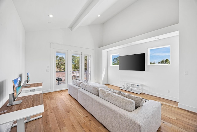 living room featuring beam ceiling, high vaulted ceiling, and light hardwood / wood-style flooring