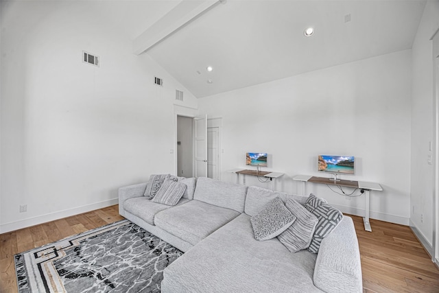 living room with beam ceiling, light hardwood / wood-style floors, and high vaulted ceiling