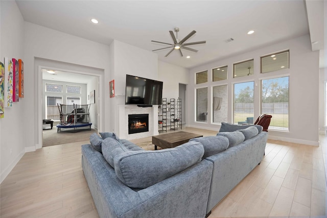 living room with ceiling fan and light hardwood / wood-style floors