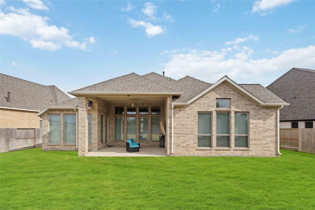 back of house featuring a patio area and a yard