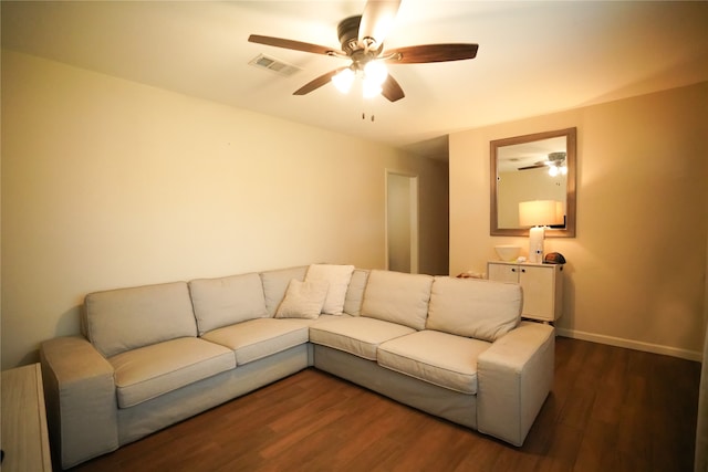 living room featuring ceiling fan and dark hardwood / wood-style floors