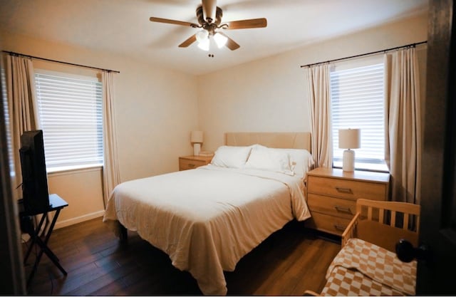 bedroom with multiple windows, ceiling fan, and dark hardwood / wood-style floors