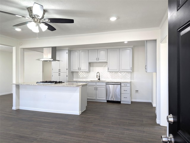 kitchen with light stone countertops, sink, stainless steel appliances, wall chimney range hood, and tasteful backsplash