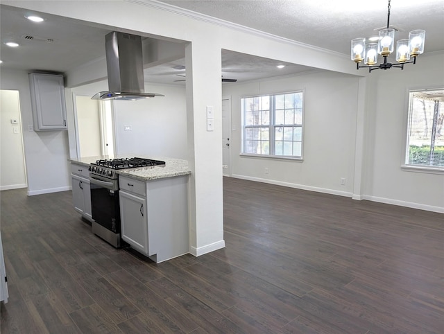 kitchen with light stone countertops, dark hardwood / wood-style flooring, stainless steel gas range, an inviting chandelier, and range hood