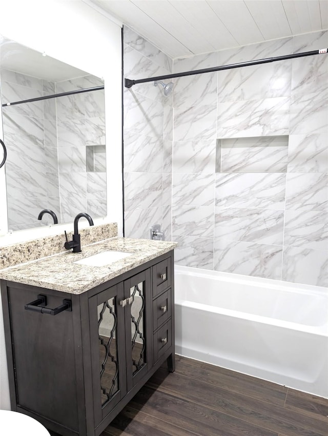 bathroom with hardwood / wood-style floors, vanity, and bathtub / shower combination