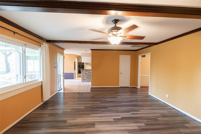 empty room with ceiling fan, dark hardwood / wood-style flooring, and ornamental molding