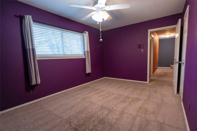 empty room featuring light carpet and ceiling fan