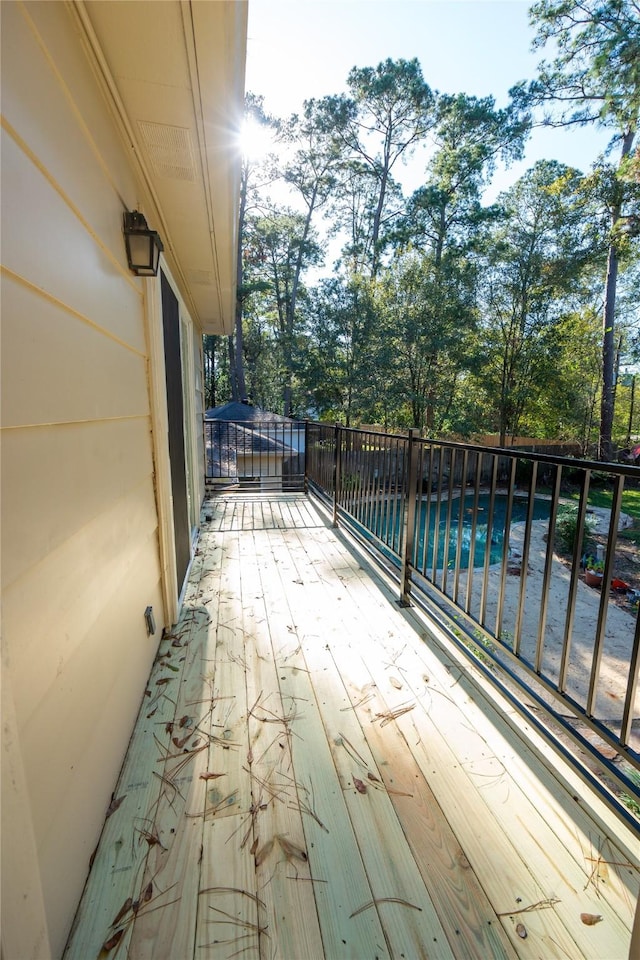 wooden deck featuring a fenced in pool