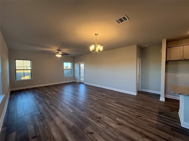 interior space with dark hardwood / wood-style flooring and ceiling fan with notable chandelier