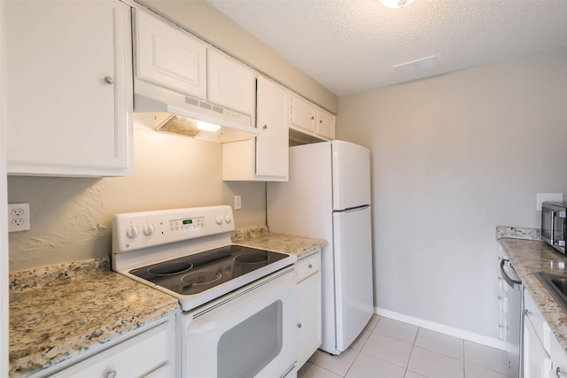 kitchen with white appliances, white cabinets, light stone countertops, a textured ceiling, and light tile patterned flooring