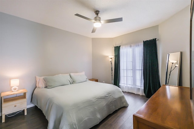 bedroom with ceiling fan and dark wood-type flooring