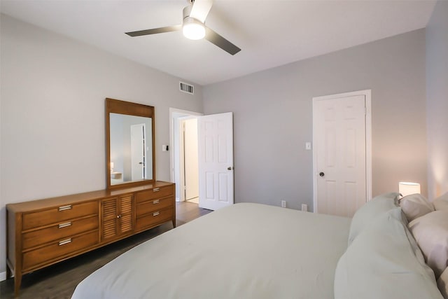 bedroom with dark hardwood / wood-style flooring and ceiling fan