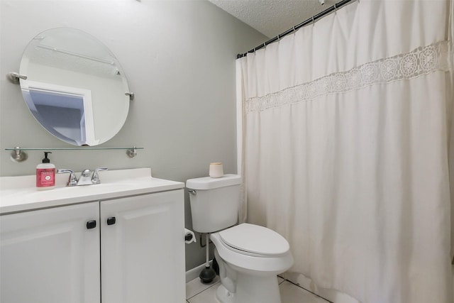 bathroom with tile patterned floors, vanity, toilet, and a textured ceiling