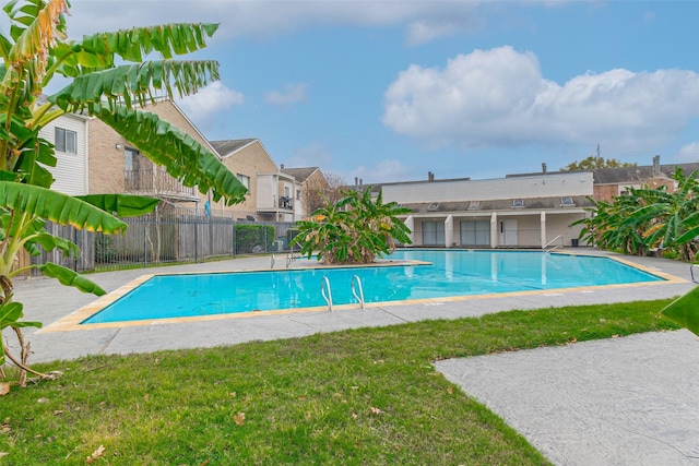 view of swimming pool with a lawn and a patio