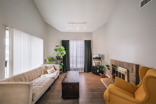 living room with dark hardwood / wood-style floors and a brick fireplace