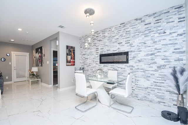 dining area featuring a tiled fireplace