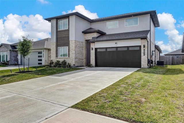 modern home with central AC, a front yard, and a garage