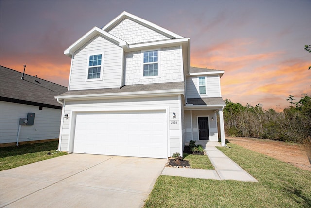 view of front of house with a lawn and a garage