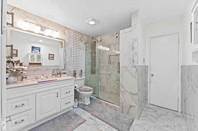 bathroom featuring vanity, toilet, a shower with shower door, and tile walls