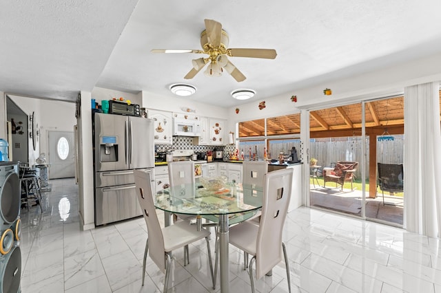 dining room featuring a textured ceiling and ceiling fan