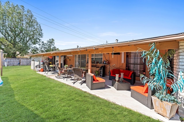 rear view of house featuring an outdoor living space, a patio, and a lawn