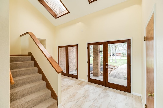 entrance foyer featuring high vaulted ceiling and french doors