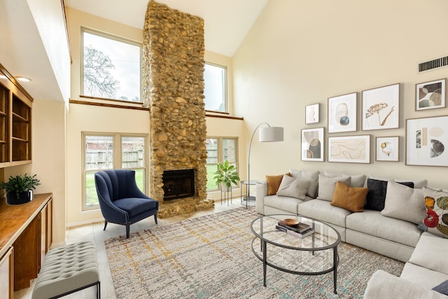 living room featuring a fireplace and high vaulted ceiling