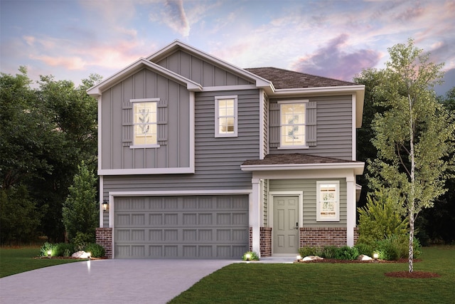 view of front of property featuring a lawn and a garage