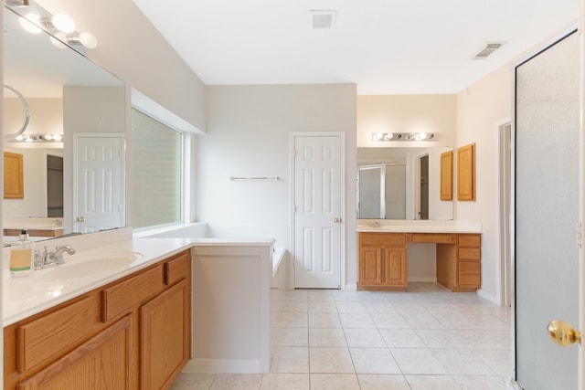 bathroom featuring vanity, tile patterned floors, and walk in shower