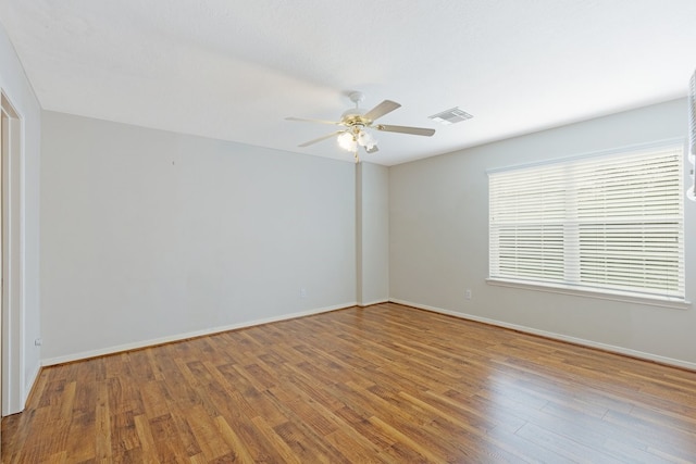 unfurnished room with ceiling fan and wood-type flooring