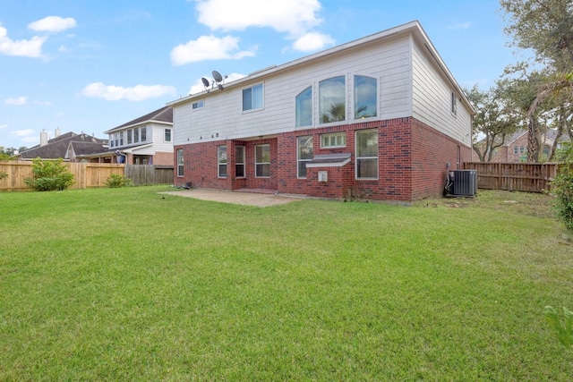 back of property with a lawn, a patio area, and central air condition unit