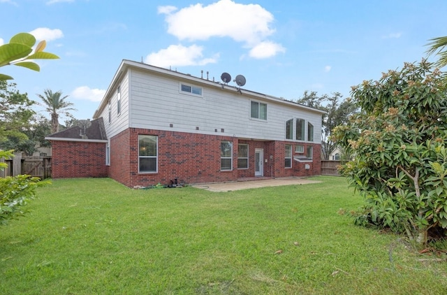 back of house with a lawn and a patio area