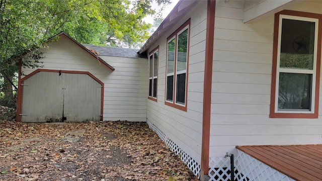 view of side of home with a storage unit