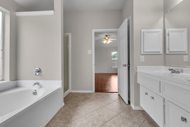 bathroom with tile patterned flooring, vanity, ceiling fan, and plus walk in shower