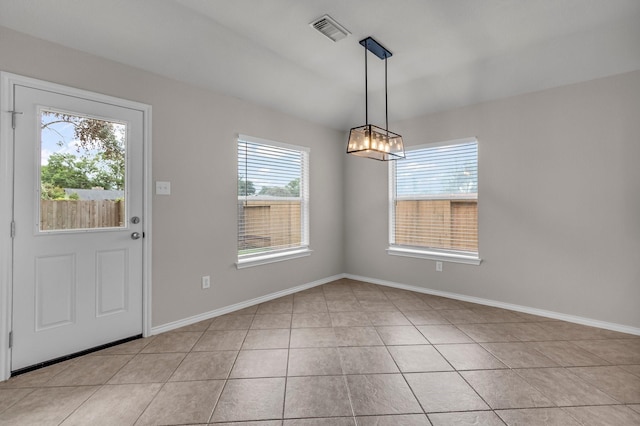 unfurnished dining area with light tile patterned floors