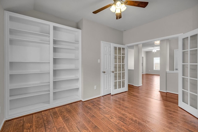 empty room with french doors, hardwood / wood-style flooring, and ceiling fan