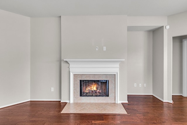 unfurnished living room featuring a fireplace and wood-type flooring