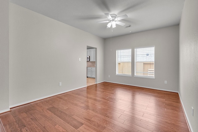 empty room featuring light hardwood / wood-style flooring and ceiling fan