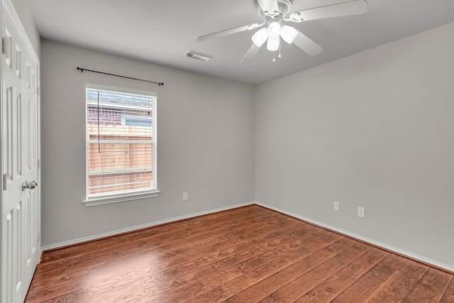 spare room featuring dark hardwood / wood-style floors and ceiling fan